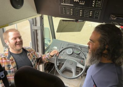 Chris Perez listens to DoIT engineer Nate as they set up equipment for an emergency command vehicle outside Chimayo Wednesday