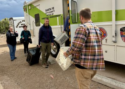 DoIT enginner Nate Wiesner arrives to set up a mobile emergency dispatch center outside Chimayo Wednesday.